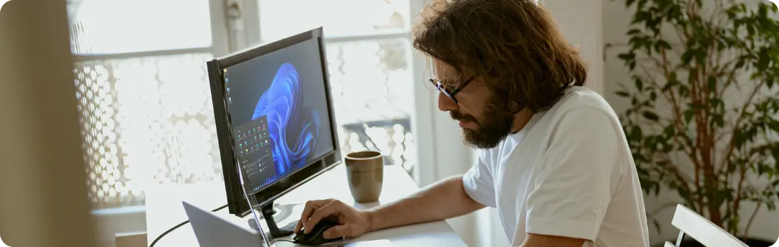 Person working remotely, demonstrating Windows 11's support for hybrid and remote workflows with security and flexibility.