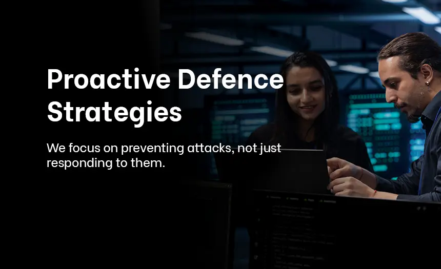 Two cybersecurity professionals strategizing in a control room, emphasizing proactive defense measures.