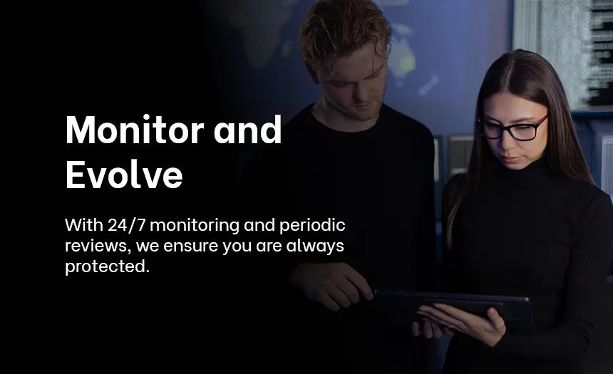 Cybersecurity professionals reviewing data on a tablet, demonstrating 24/7 monitoring and adaptive strategies.