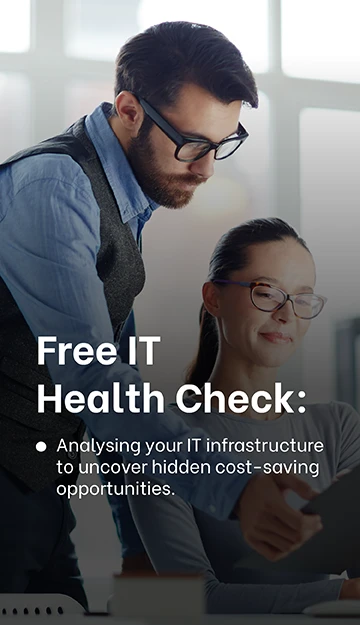 Two colleagues collaborating in an office setting, with a man showing a tablet to a smiling woman seated at a desk. The text on the left reads: 'Free IT Health Check: Analysing your IT infrastructure to uncover hidden cost-saving opportunities.