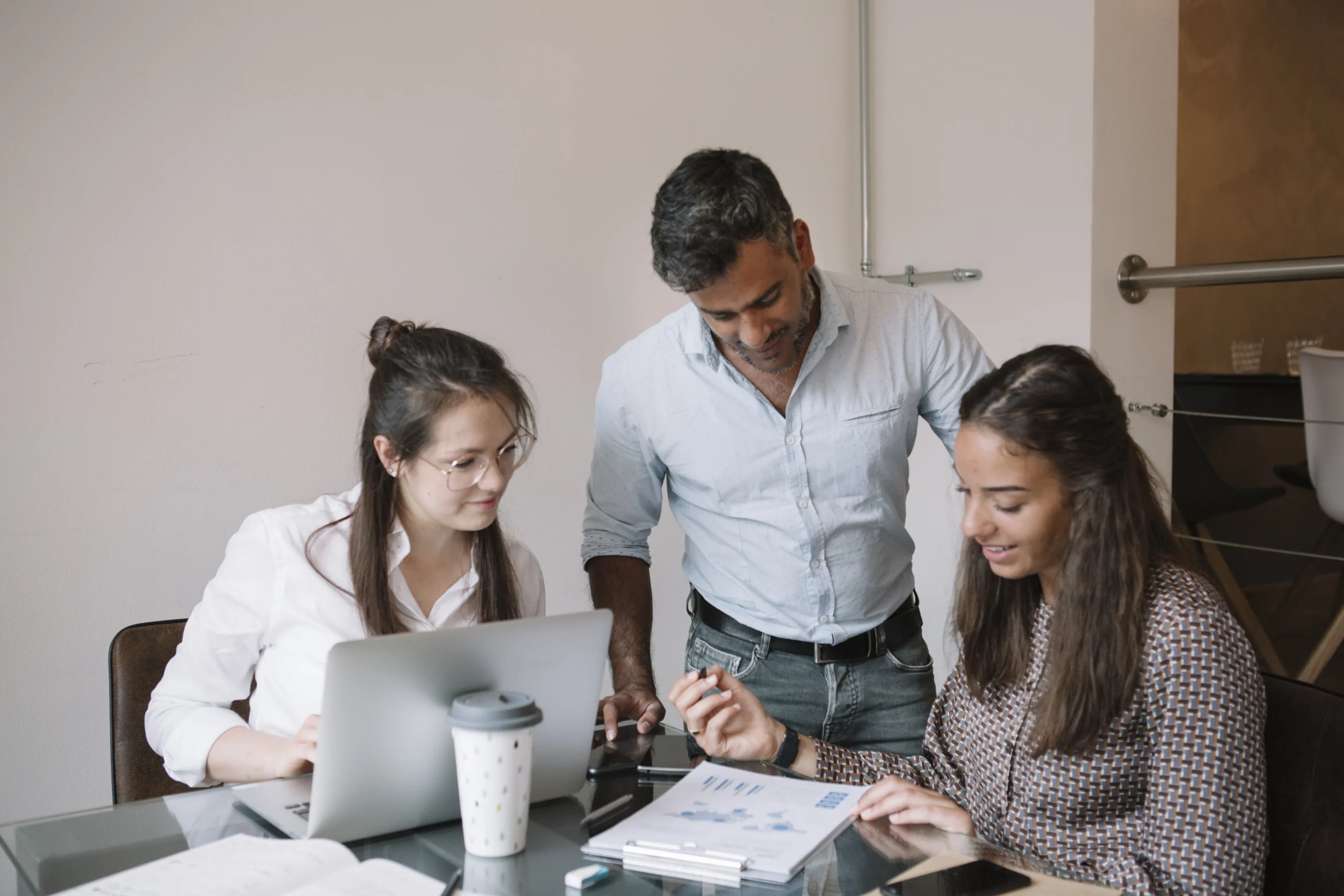 Business team in a collaborative meeting, discussing value assessment, ROI maximization, and continuous optimization for Microsoft Fabric.