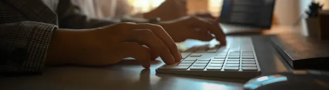 Close-up of hands on a keyboard, representing Azure Integration Services for hybrid cloud and on-premises workflows by Exigo Tech in Singapore