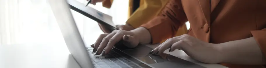 Hands typing on a laptop representing Dynamics 365 business solutions by ExigoTech in Singapore