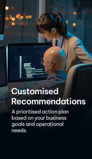 Professionals discussing customized cybersecurity recommendations with multiple monitors - For Mobile version