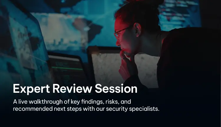 Security specialist reviewing data and findings on multiple monitors during an expert session