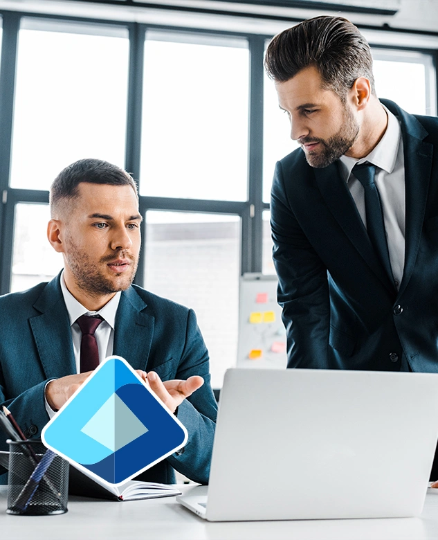 Two professionals collaborating on a laptop with the Microsoft Entra ID logo, representing secure identity management and multi-factor authentication.