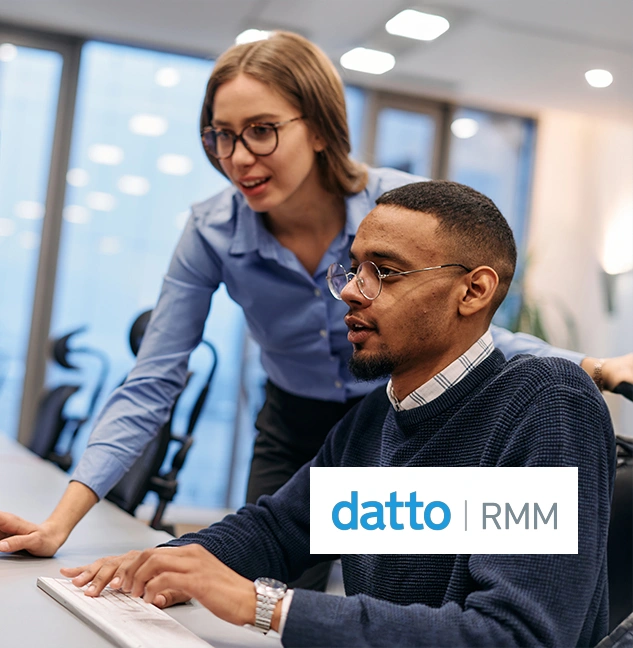 Business team reviewing Datto RMM dashboard for automated patching, monitoring, and system health optimisation.