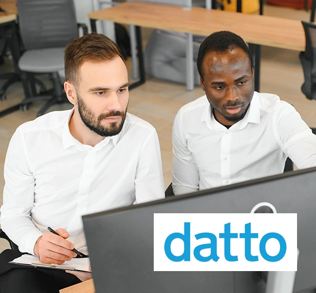 Two IT professionals configuring Datto BCDR solution for automated ransomware protection and business continuity.