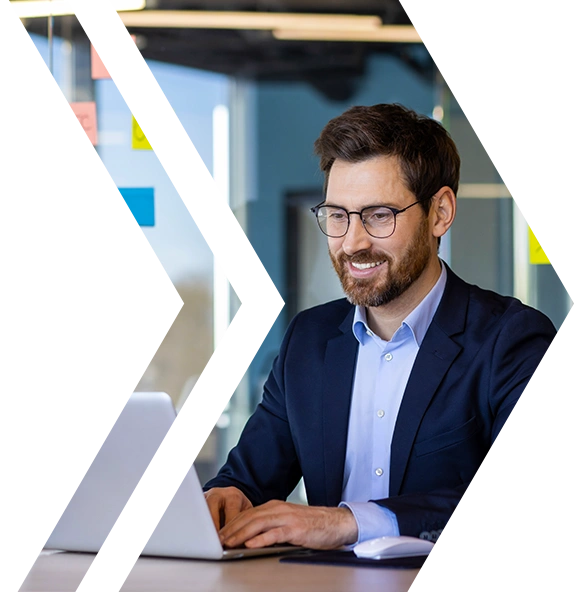 CTA - Smiling professional working on a laptop, representing secure, automated OS patching with Microsoft Intune and Datto RMM.